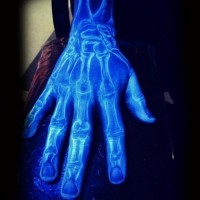 Magical white ink luminescence hand bones tattoo on hand and arm
