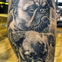 Magnificent black and white little dogs tattoo on leg