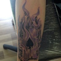 Magnificent black ink spades playing card in flames tattoo on arm