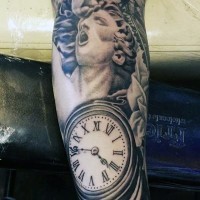 Magnificent black ink statue tattoo on forearm with old clock