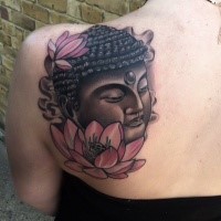 Magnificent Buddha and pale pink lotus flowers Hinduism tattoo on shoulder blade