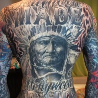 Magnificent massive very detailed old Indian portrait tattoo on whole back stylized with lettering