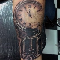 Magnificent painted antic old clock with candles tattoo on arm