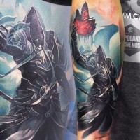 Magnificent very detailed big colored dark warrior tattoo on forearm with red magical crystal