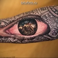 Magnificent very detailed colorful eye tattoo on forearm stylized with Egypt pyramids and ornaments