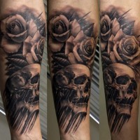 Marvelous black ink rose flowers tattoo on forearm combined with human skull