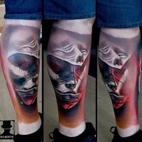 Marvelous colored leg tattoo of mystical human faces