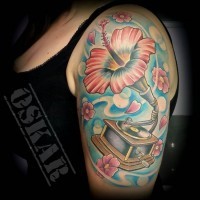 Marvelous looking multicolored flower shaped gramophone tattoo on shoulder