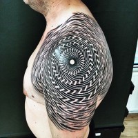 Massive black and white hypnotic ornament tattoo on shoulder