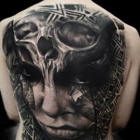 Massive black and white mystical tribal woman portrait tattoo on whole back with human skull