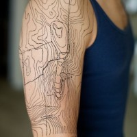 Massive black ink realistic looking shoulder tattoo of map part