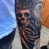 Massive detailed colored skeleton with crown tattoo on sleeve