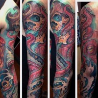Massive natural colored underwater octopus with skull tattoo on sleeve