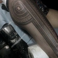 Massive very detailed black ink tribal tattoo on whole leg