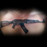 Medium size colored chest tattoo of AK 47 rifle