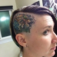 Medium size illustrative style head tattoo of leopard with jewelry and flower