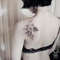 Medium size small scapular tattoo of small flowers and plane by Zihwa