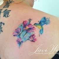 Medium size watercolor style beautiful looking shoulder tattoo of hummingbird and flowers