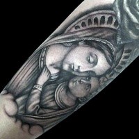 Medium sized black ink religious style tattoo on forearm