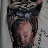memorial style colored shoulder tattoo of little baby with angel