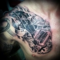 Memorial style desinged black and white musical tattoo on chest with letteirng