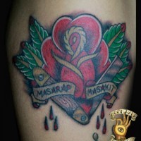 Memorial style simple colored rose with bloody razor blade and lettering tattoo on leg
