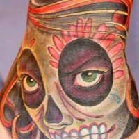 Mexican native multicolored hand tattoo of demonic woman face