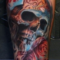 Mexican style colored forearm tattoo of human skull with roses