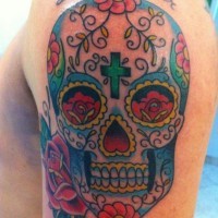 Mexican sugar skull and green cross on forehead tattoo