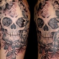 Mexican traditional colored shoulder tattoo of human skull with flowers and butterflies