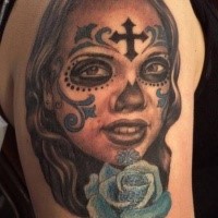 Mexican traditional style colored shoulder tattoo of woman with flowers and cross