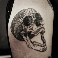 Mexican traditional style colored shoulder tattoo of big human skull with ornaments