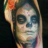 Mexican traditional style colorful shoulder tattoo of woman portrait and flower