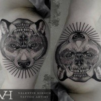 Mirrored dot style biceps tattoo of wolf head combined with human skull