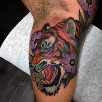 Modern style colored biceps tattoo of roaring tiger with flowers