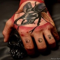 Modern style colored hand tattoo of big bug with circles
