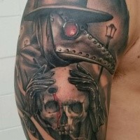 Modern style colored upper arm tattoo of plague doctor with human skull