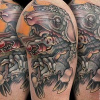 Modern style painted and colored bloody wolf in sheep's skin tattoo on upper arm area