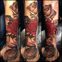 Modern traditional style colored arm tattoo of roses with vintage clock