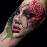 Modern traditional style colored biceps tattoo of woman face with roses