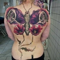 Modern traditional style colored butterfly shaped tattoo on back with human skulls and flowers