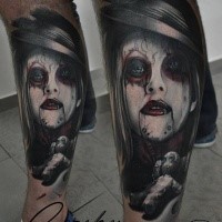 Modern traditional style colored leg tattoo of terrifying woman portrait with voodoo doll