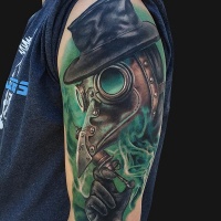 Modern traditional style colored shoulder tattoo of fantasy man with mask and green fox