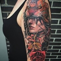 Modern traditional style colored shoulder tattoo of woman portrait with helmet made from tiger skin