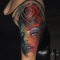 Modern traditional style colored shoulder tattoo of woman face with rose