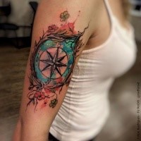 Modern traditional style colored shoulder tattoo of compass with flowers