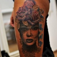 Modern traditional style colored thigh tattoo of woman face with flowers