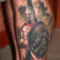 Muscular Spartan warrior with shield realistic traditionally colored tattoo on calf with haze