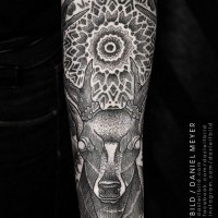Mysterious big black and white deer with flower shaped ornaments tattoo on sleeve