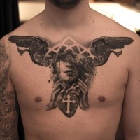 Mysterious black ink chest tattoo of woman face with human heart and wings